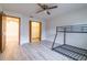Bedroom featuring bunkbeds, a closet with bi-fold doors leading to a walk-in closet, and a full size door at 828 Ne 51St Ave, Ocala, FL 34470