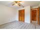 Bedroom featuring wood-look flooring and a wooden closet with bi-fold doors at 828 Ne 51St Ave, Ocala, FL 34470