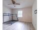 Bedroom features wood-look flooring, a bunk bed, and a window at 828 Ne 51St Ave, Ocala, FL 34470