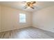 Bedroom with ceiling fan, wood-look flooring, and bright natural light through a window at 828 Ne 51St Ave, Ocala, FL 34470
