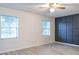 Spacious bedroom with a feature wall and plenty of natural light from two windows at 828 Ne 51St Ave, Ocala, FL 34470