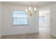 Light filled dining room features a window with blinds and a vintage chandelier at 828 Ne 51St Ave, Ocala, FL 34470