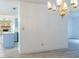 Bright dining room featuring an ornate chandelier and modern wood-look flooring at 828 Ne 51St Ave, Ocala, FL 34470