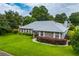 Beautiful home featuring brick accents, white shutters, manicured landscaping, and a well-maintained lawn at 828 Ne 51St Ave, Ocala, FL 34470