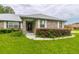 Charming brick home with well-maintained lawn, decorative shutters, and welcoming front entrance at 828 Ne 51St Ave, Ocala, FL 34470