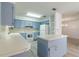 Cozy kitchen with light blue cabinets, white appliances, and center island at 828 Ne 51St Ave, Ocala, FL 34470
