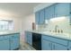 Functional kitchen with blue cabinets, dual sink, and stainless-steel appliances at 828 Ne 51St Ave, Ocala, FL 34470