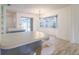 Bright open-concept kitchen featuring an island, large windows, and sliding glass doors to outdoor space at 828 Ne 51St Ave, Ocala, FL 34470