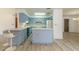 Open kitchen concept with seating, central island, and view into dining area at 828 Ne 51St Ave, Ocala, FL 34470