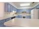 Spacious kitchen featuring blue cabinets, white countertops, and stainless steel appliances at 828 Ne 51St Ave, Ocala, FL 34470