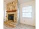 Living room fireplace constructed of stacked stone with a wood mantle at 828 Ne 51St Ave, Ocala, FL 34470