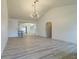 Open living room with modern light fixture, bar seating, and view into dining room at 828 Ne 51St Ave, Ocala, FL 34470