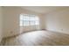 View of living space with gray wood-look floors, a bay window and white walls at 828 Ne 51St Ave, Ocala, FL 34470