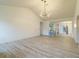 Bright living room with modern light fixture, bar seating, and view into dining area at 828 Ne 51St Ave, Ocala, FL 34470