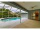 Screened-in pool area with a cool blue pool, patio space, and sliding glass doors to the house at 828 Ne 51St Ave, Ocala, FL 34470