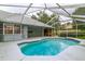 Sparkling blue pool in a screened enclosure, offering a refreshing retreat with surrounding patio space at 828 Ne 51St Ave, Ocala, FL 34470