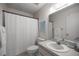 Bright bathroom featuring a sink, toilet, shower, and a large mirror at 8712 Sw 92Nd Pl # D, Ocala, FL 34481