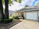 Charming exterior of home with attached garage, landscaping, and covered porch, creating a welcoming curb appeal at 8712 Sw 92Nd Pl # D, Ocala, FL 34481