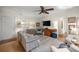 Bright living room featuring hardwood floors, shuttered windows, and comfortable seating arrangement at 8712 Sw 92Nd Pl # D, Ocala, FL 34481