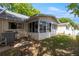 Exterior view of the sunroom with a sliding glass door and large windows at 8712 Sw 92Nd Pl # D, Ocala, FL 34481