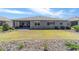 Landscaped backyard with manicured lawn and mature bushes viewed from slightly above ground level at 8820 Sw 104Th Cir, Ocala, FL 34481