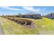 Expansive backyard with landscaping beds, green grass, and neighboring homes in the background at 8820 Sw 104Th Cir, Ocala, FL 34481