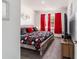 Bright bedroom featuring red curtains, carpet flooring, and a stylish wooden bed frame at 8820 Sw 104Th Cir, Ocala, FL 34481