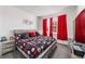 Well-lit bedroom showcasing a unique bed frame, red curtains, and comfortable decor at 8820 Sw 104Th Cir, Ocala, FL 34481