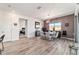 Open dining room features gray accent wall, modern light fixture, and wood-look flooring at 8820 Sw 104Th Cir, Ocala, FL 34481