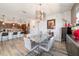 Open dining room featuring a granite table, modern light fixture, and breakfast bar at 8820 Sw 104Th Cir, Ocala, FL 34481