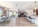 Open-concept dining space with modern lighting, patio view, and seamless flow to living area at 8820 Sw 104Th Cir, Ocala, FL 34481