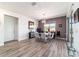 Modern dining room showcasing contemporary light fixture, wood-look floors, and sliding glass doors at 8820 Sw 104Th Cir, Ocala, FL 34481