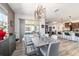 Bright dining area boasts modern light fixture, wood-look floors, and seamless transition to living spaces at 8820 Sw 104Th Cir, Ocala, FL 34481