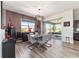 Elegant dining room featuring stylish table, wood-look floors, and view to outdoor living space at 8820 Sw 104Th Cir, Ocala, FL 34481