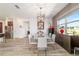 Bright dining room features modern table set, wood-look floors, and open access to kitchen at 8820 Sw 104Th Cir, Ocala, FL 34481