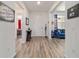 Bright entryway with wood-look floors and views into the living room and bedroom at 8820 Sw 104Th Cir, Ocala, FL 34481