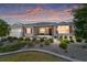 Charming single-story home featuring manicured landscaping and a neutral color palette at sunset at 8820 Sw 104Th Cir, Ocala, FL 34481