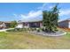 Landscaped front yard with vibrant green grass and a mature shade tree at 8820 Sw 104Th Cir, Ocala, FL 34481