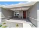 Covered front porch with a bench, stylish light fixtures, and a decorative door at 8820 Sw 104Th Cir, Ocala, FL 34481
