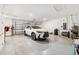 Spacious two car garage with epoxy flooring, a late model SUV, and ample storage at 8820 Sw 104Th Cir, Ocala, FL 34481