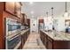 This kitchen features stainless steel appliances, granite countertops, and dark wood cabinetry at 8820 Sw 104Th Cir, Ocala, FL 34481