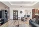 Open-concept living space showcasing hardwood floors and comfortable furniture with a view to the kitchen at 8820 Sw 104Th Cir, Ocala, FL 34481