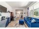 Inviting living room with a blue sofa set, natural light, and a view into other living spaces at 8820 Sw 104Th Cir, Ocala, FL 34481