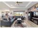 Open living area with kitchen view, complete with a modern sectional and wood-style flooring at 8820 Sw 104Th Cir, Ocala, FL 34481