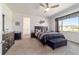 Comfortable bedroom featuring neutral carpet, ceiling fan, and generous natural light at 8820 Sw 104Th Cir, Ocala, FL 34481