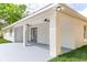 Exterior view of the covered patio area with ceiling fans and manicured backyard at 8878 Sw 133Rd Lane Rd, Ocala, FL 34473