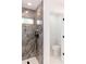 Close-up of bathroom tiled shower and glass door, with a partial view of the toilet at 8878 Sw 133Rd Lane Rd, Ocala, FL 34473
