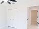 Bright bedroom featuring a closet, ceiling fan, neutral wall colors, and interior entry door at 8878 Sw 133Rd Lane Rd, Ocala, FL 34473