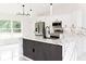 Bright, white kitchen featuring stainless steel appliances, marble countertops, and an island with a sink at 8878 Sw 133Rd Lane Rd, Ocala, FL 34473