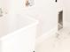 Bright laundry room features white tile floors, utility sink, and convenient washer/dryer hookups at 8878 Sw 133Rd Lane Rd, Ocala, FL 34473